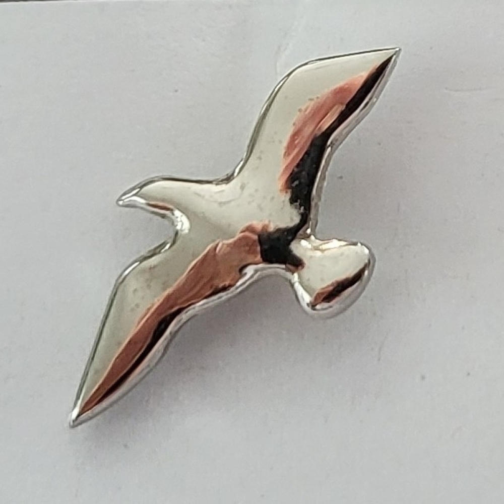 Silver-tone bird lapel pin stamped H.A.S Marketing.